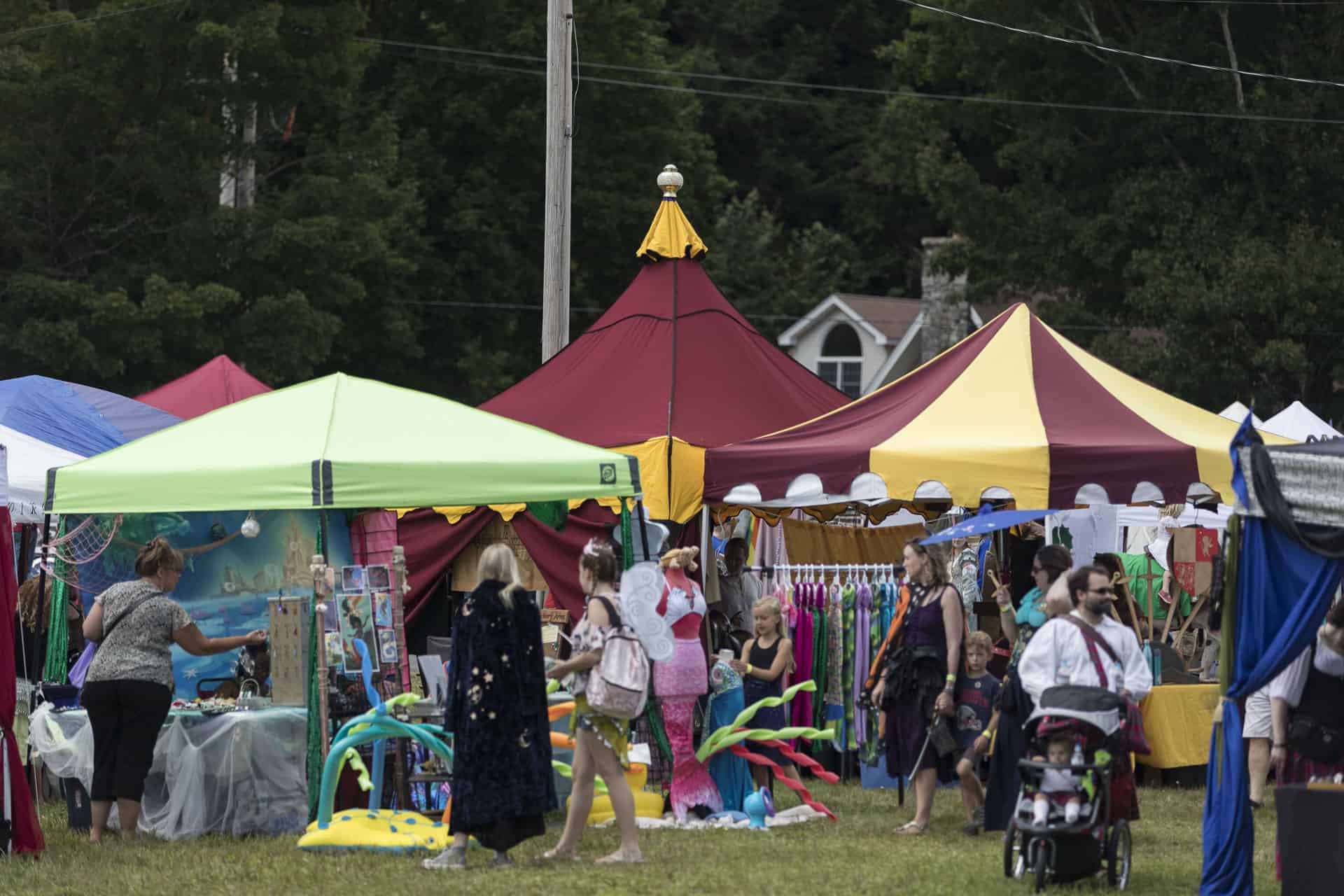 Vendor booths and shoppers at the Market of the Moons