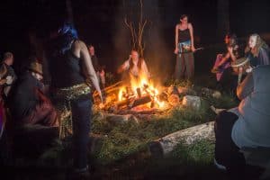 People dancing around a campfire