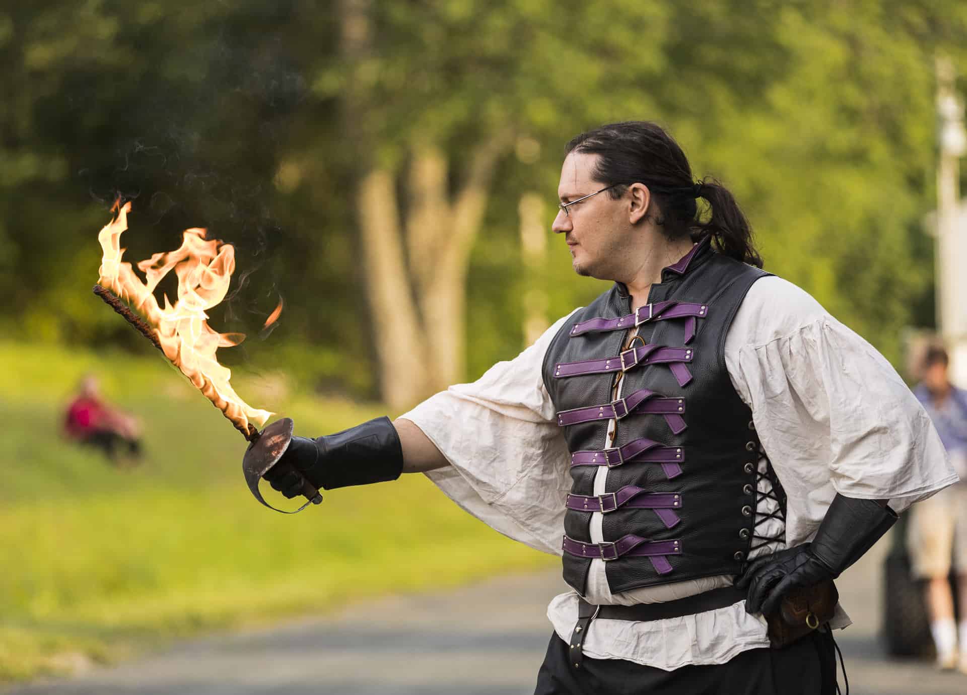 man holding flaming sword fire performer
