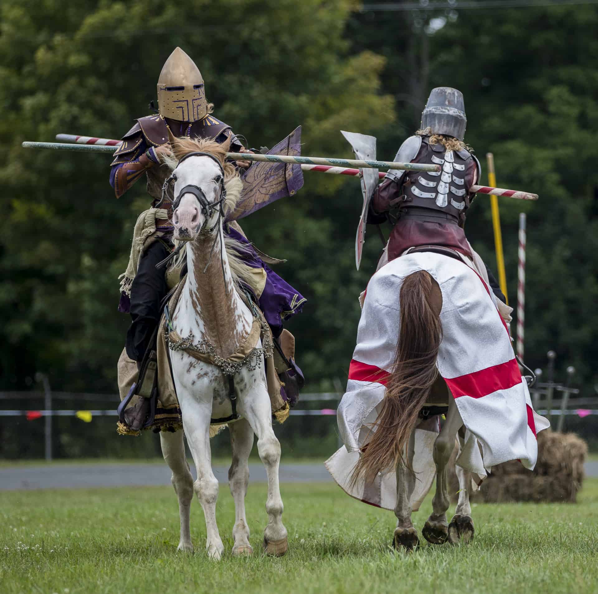 two jousters with lances hitting each other on horseback