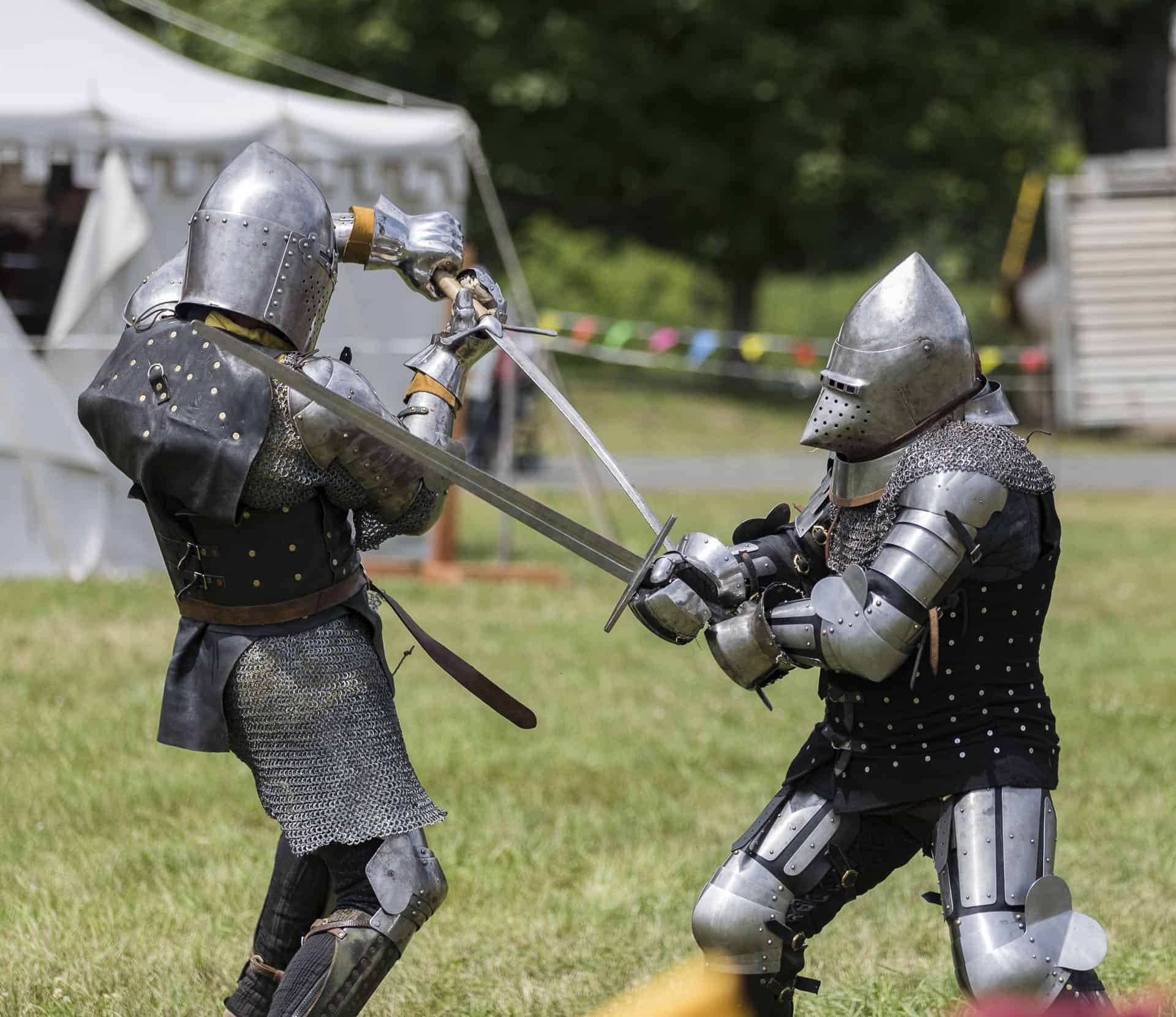 two knights fighting in full armor with swords