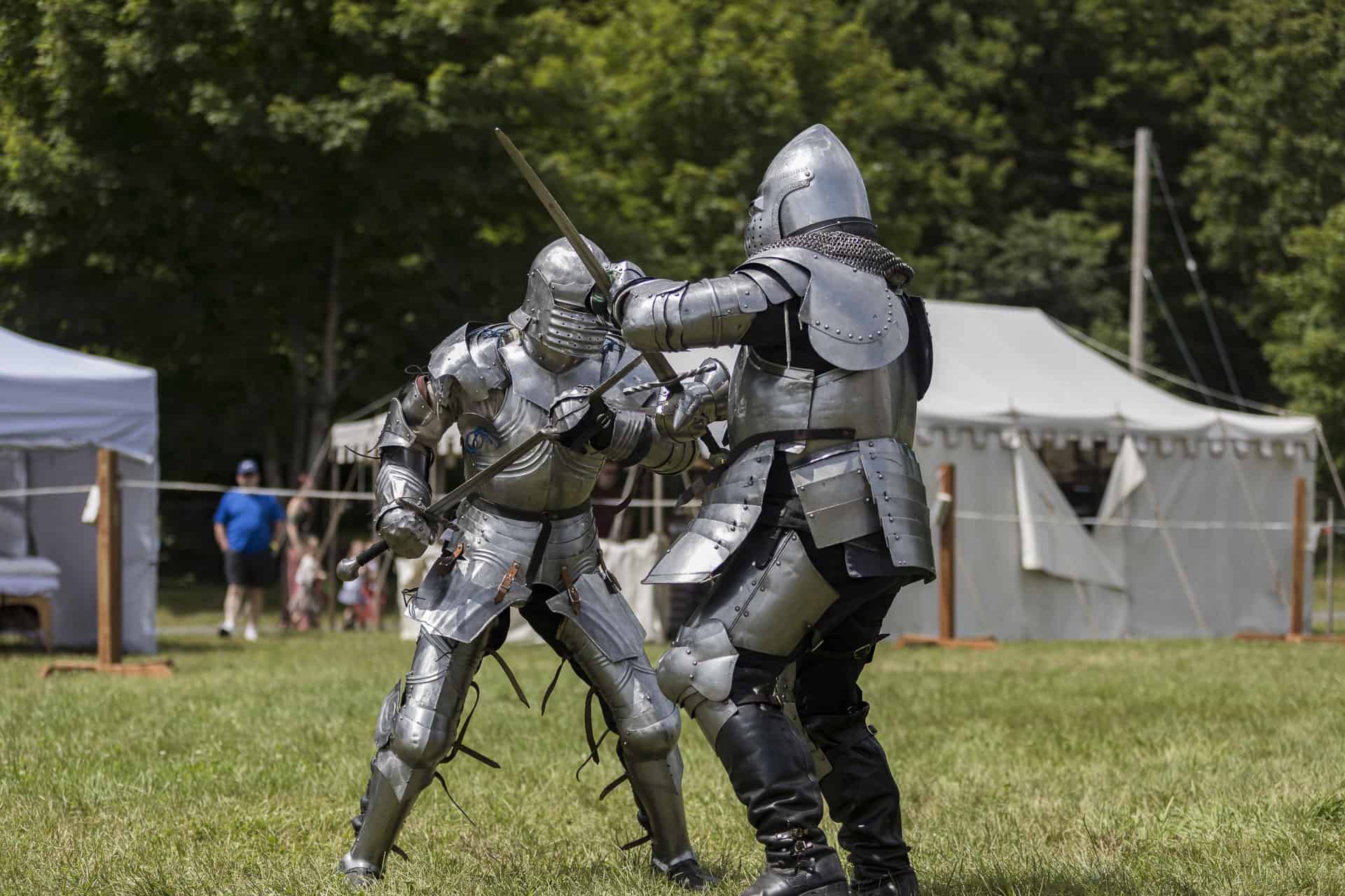 fully armored knights sparring wtih swords