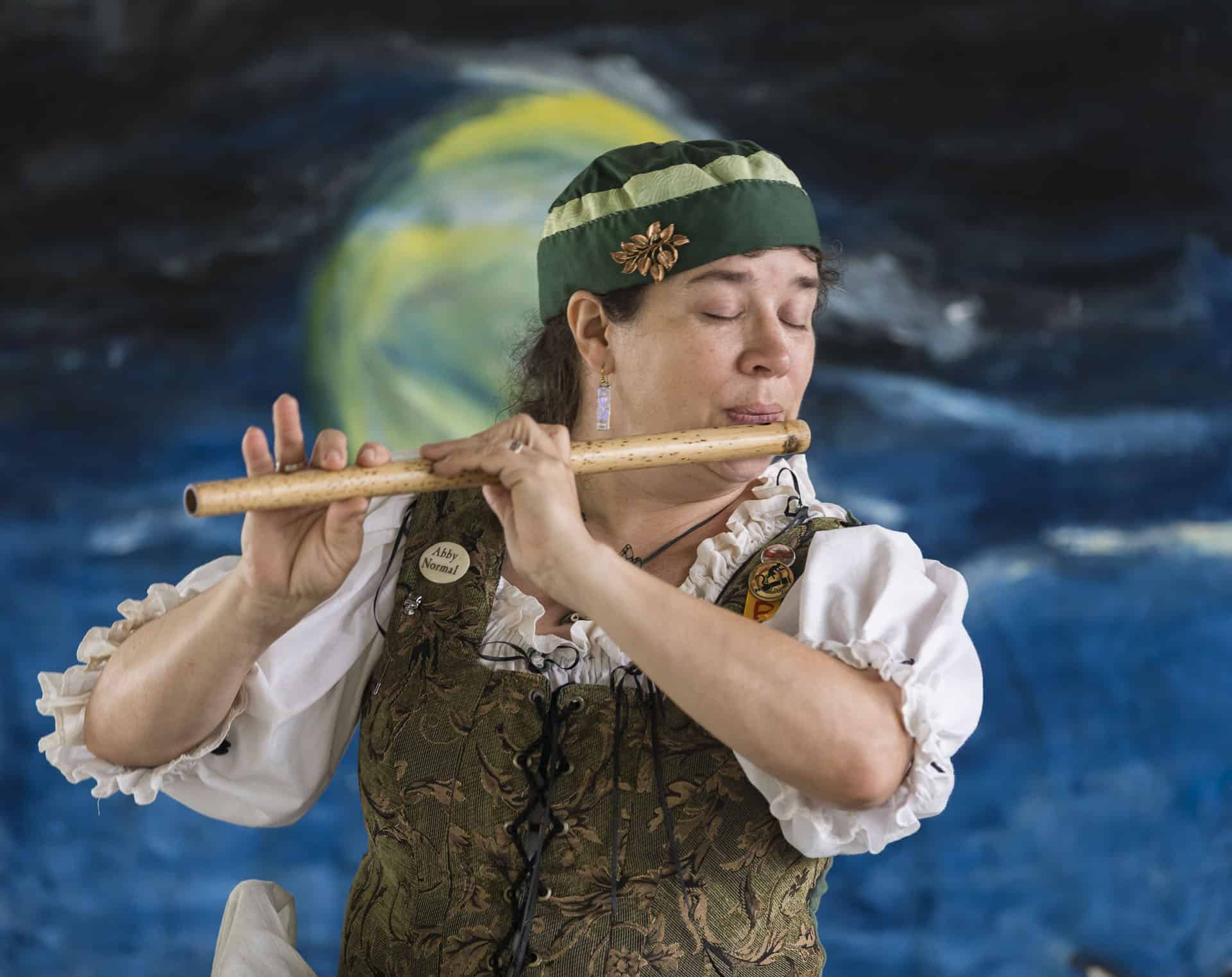 woman playing wooden flute