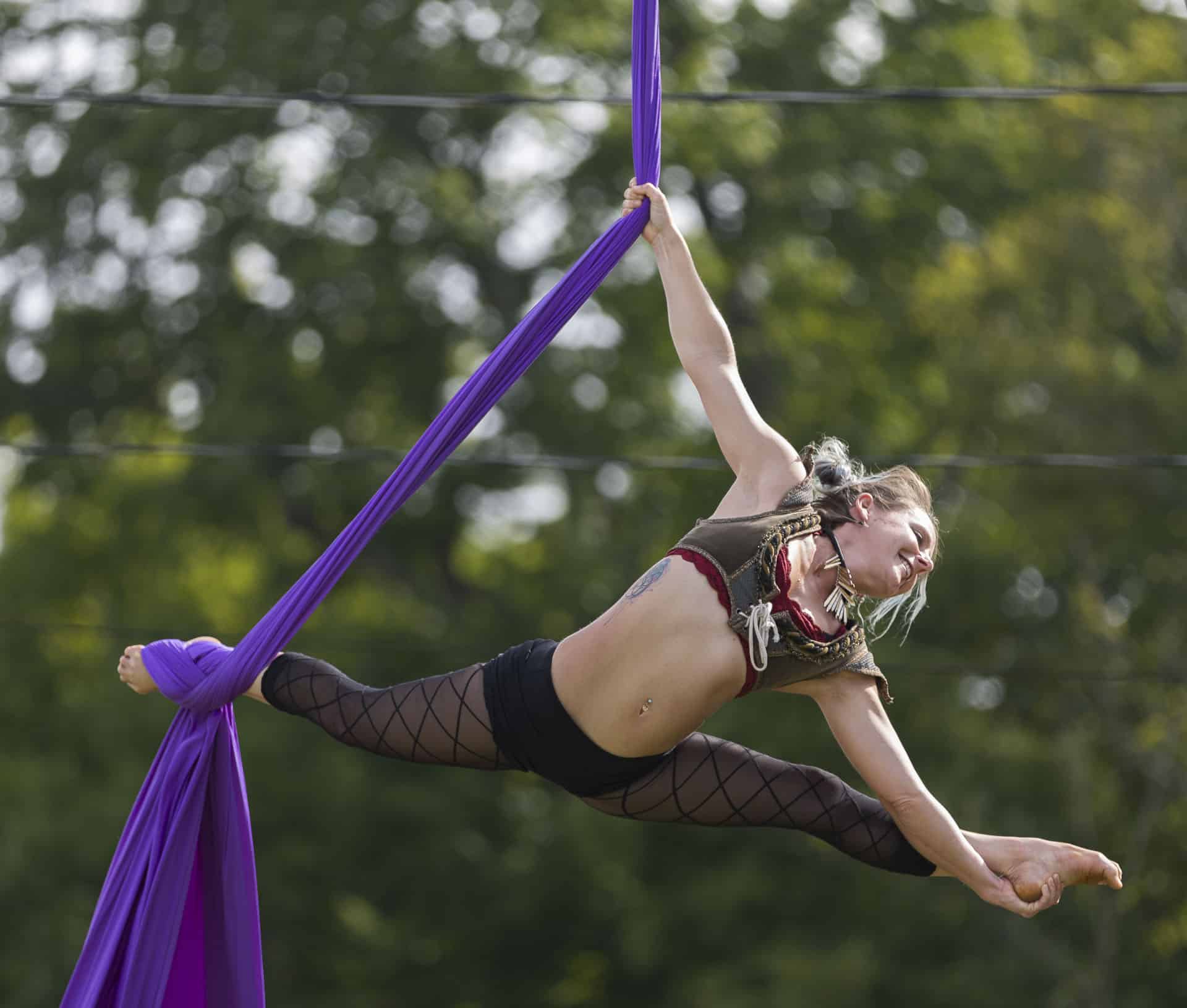 silk aerialist gymnast doing split in air